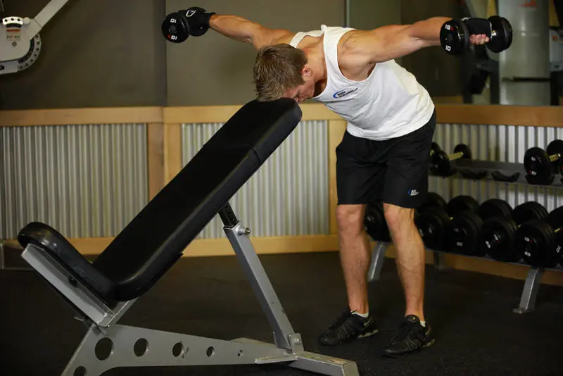 Bent Over Dumbbell Rear Delt Raise With Head On Bench — finish position