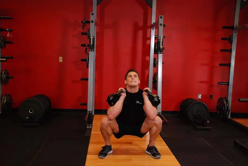 Front Squats With Two Kettlebells — finish position