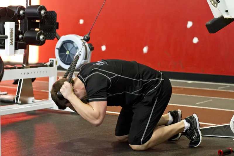 Kneeling Cable Crunch With Alternating Oblique Twists — finish position