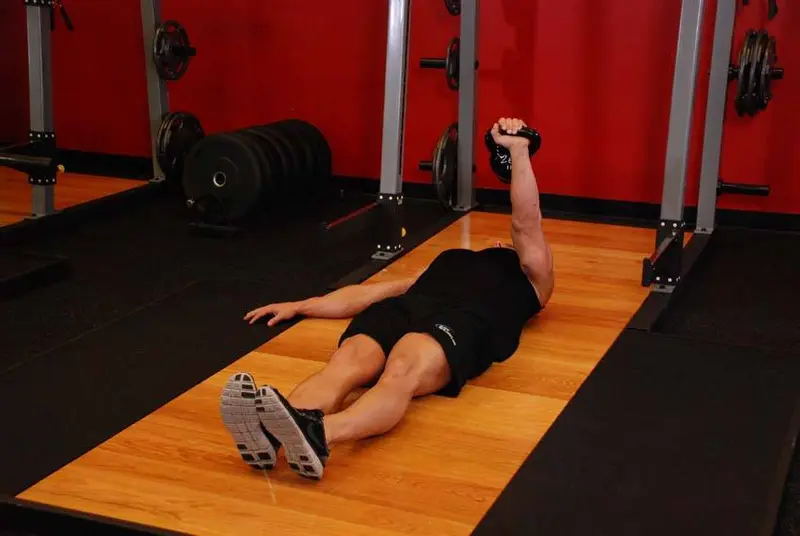 One-Arm Kettlebell Floor Press — finish position