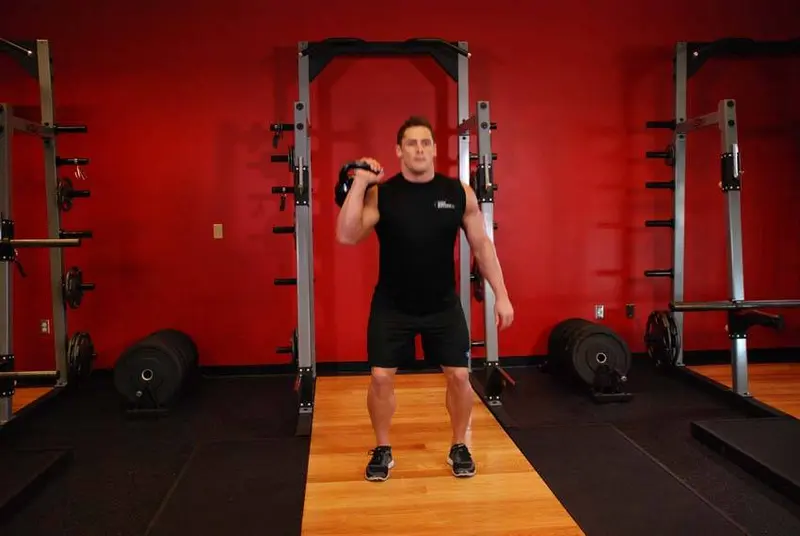 One-Arm Kettlebell Split Jerk — finish position