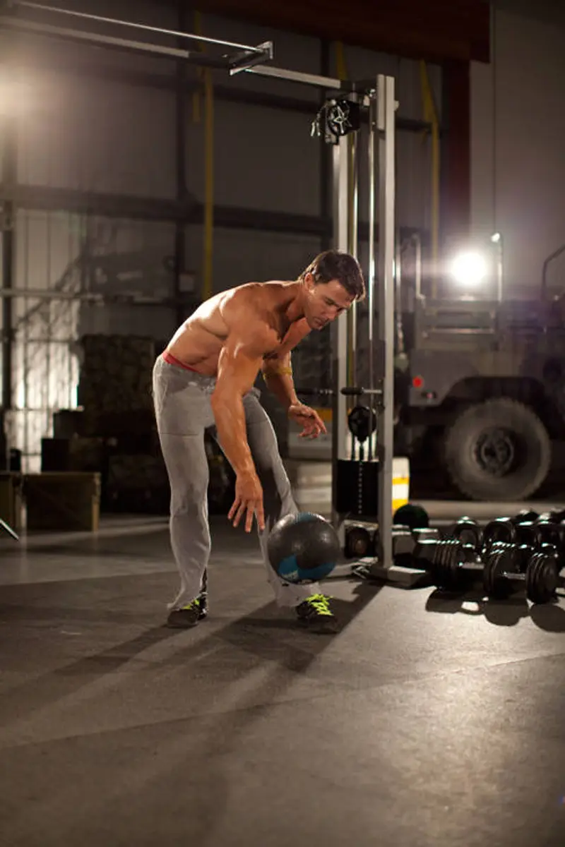 One-Arm Medicine Ball Slam — finish position