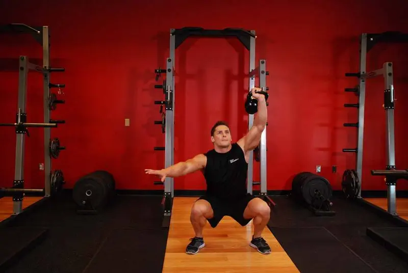 One-Arm Overhead Kettlebell Squats — finish position