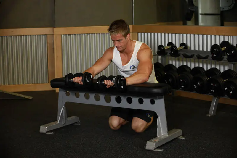 Palms-Down Dumbbell Wrist Curl Over A Bench — finish position