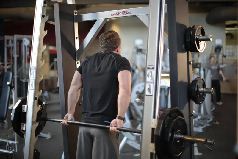 Smith Machine Behind the Back Shrug — finish position