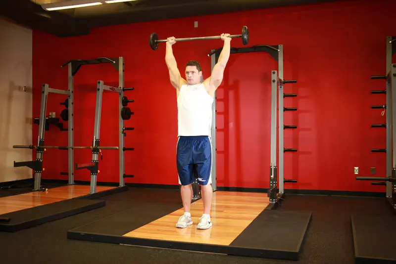 Standing Barbell Press Behind Neck — finish position