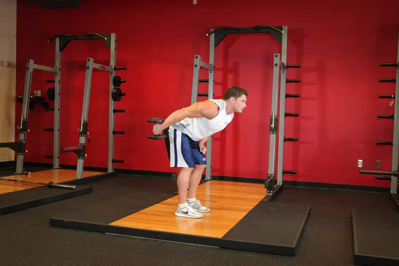 Standing Bent-Over One-Arm Dumbbell Triceps Extension — finish position