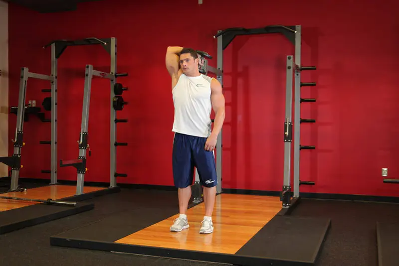 Standing One-Arm Dumbbell Triceps Extension — finish position