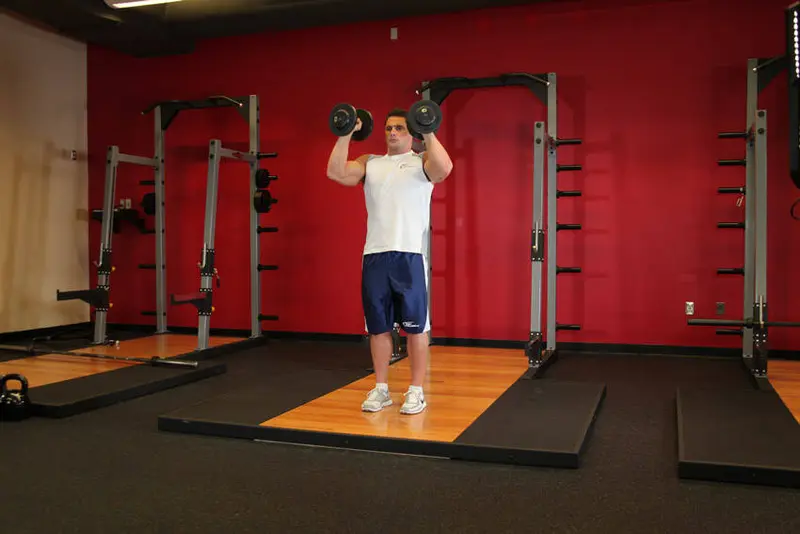 Standing Palms-In Dumbbell Press — finish position