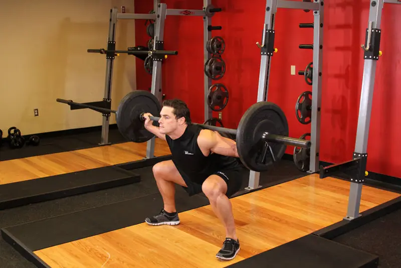 Wide Stance Barbell Squat — finish position